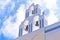 Santorini Greece Church with bells and cross against blue sky