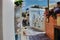 Santorini, Greece : A narrow commercial street with Jewelery shop on the left, tourist walking in the middle