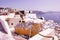 Santorini, Greece : Narrow streets, Cyclades architecture hotels houses and cafes over the caldera in Oia