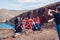 Santorini, Greece - November 1, 2019: Tourists from China make communist star with red scarfs on Red beach to take photo