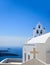Santorini, Greece. White church and bells against blue sea and sky background
