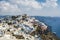 Santorini, Greece, white and colorful houses built on hills of caldera over the Mediterranean Sea.