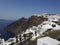 Santorini, Greece: Wide angle shot of Santorini cityscape in the town of Oia against dramatic clouds. Small