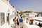 Santorini, Greece : Wide angle shot of Tourists walking on a commercial market between cafes and restaurants