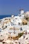 Santorini island holidays in Greece travel traveling Oia town Mediterranean Sea with windmills Santorin portrait format