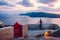 Santorini island Oia sunset landscape. Tourist enjoys Caldera sea view in dusk on roof top. Travel to Greece