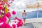 Santorini Oia hotel luxury resort tourist woman looking at view from balcony - Greece summer travel vacation