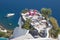 Santorini - The restaurant geared to wedding romantic diner in Oia (Ia) and the yacht under cliffs