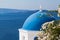 Santorini skyline. Beautiful Santorini landscape with sea, sky and blue church dome in white flowers