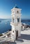 Santorini - The tower of Anastasi church in Imerovigli with the Nea Kameni island