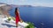 Santorini Travel Vacation Tourist Looking At Caldera View and Aegean Sea Greece