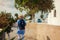 Santorini traveler exploring discovering greek architecture in Akrotiri. Woman backpacker walking during vacation