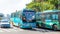 Sanya, China - May 15, 2019: Road traffic. A lot of electric cars. Hybrid buses. 90 percent of mopeds are electric