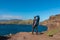 Sao Lourenco - Father with baby carrier looking at majestic Atlantic Ocean coastline at Ponta de Sao Lourenco peninsula