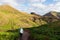 Sao Lourenco - Hiker woman on idyllic hiking trail along lush green meadow at Ponta de Sao Lourenco peninsula, Canical