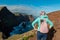 Sao Lourenco - Hiker woman with panoramic view of majestic Atlantic Ocean coastline at Ponta de Sao Lourenco peninsula