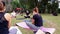 Sao Paulo, Sao Paulo/Brazil, on july 04, 2021. Camera zooming in on yoga practitioners sitting on the lawn of a public park