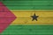 Sao Tome and Principe flag depicted in bright paint colors on old wooden wall. Textured banner on rough background