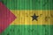 Sao Tome and Principe flag depicted in bright paint colors on old wooden wall. Textured banner on rough background