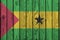 Sao Tome and Principe flag depicted in bright paint colors on old wooden wall. Textured banner on rough background