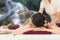 Sap Massage in waterfall nature. Masseur doing massage with treatment sugar scrub on Asian woman body in the Thai spa lifestyle,