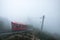 Sapa, Vietmam - Sep 08 2017 : Red tram retro style run to the top hill with passenger on foggy at Fansipan Legend