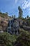 Sapokka Park in the city of Kotka in Finland. Waterfall with a cliff on the background of the lake, tourists on the bridge