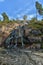 Sapokka Park in the city of Kotka in Finland. Waterfall with a cliff on the background of the lake, tourists on the bridge