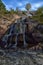 Sapokka Park in the city of Kotka in Finland. Waterfall with a cliff on the background of the lake, tourists on the bridge