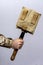 A sapper shovel in a case in the hand of a military man on a light background.