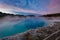 Sapphire Pool in Biscuit basin with blue steamy water and beautiful colorful sunset. Yellowstone, Wyoming