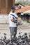 Sarajevo, Bosnia-Herzegovina, July 16 2017: Man feeds pigeons in Sarajevo