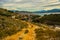 SARANDA, ALBANIA: The road in the rocks and the view from above of the houses and the coast in Saranda