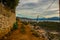 SARANDA, ALBANIA: The road in the rocks and the view from above of the houses and the coast in Saranda