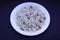 Saraswathi Pooja and Ayudha Pooja Celebrations - pori kadalai and onion in white bowl on black background.