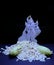 Saraswathi Pooja and Ayudha Pooja Celebrations - Silver idol Murugan with banana and pori on black background.