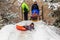 Saratov / Russia - March 8, 2018: Children ride with an ice slide. Winter vacation. Outdoor activity. Winter day in the city Park