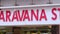 Saravana stores building exterior establishing shot. Panning shot of name board