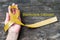Sarcoma Bone cancer awareness yellow ribbon on human helping hand, aged wood