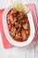 Sardines in tomato sauce, decorated with lime and parsley close-
