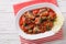 Sardines in tomato sauce, decorated with lime and parsley close-