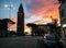 Sardinia. Carbonia. Belltower of the parrish church of St Ponziano. Backlight on the sunset sky background