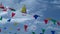 Sardinia. Popular traditions. Colorful flags waving against the cloudy blue sky.  Video