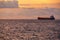 Sardinia. Portoscuso. Sunset on the sea of the Canal of St Peter. Cargo ships anchored in the harbor