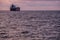 Sardinia. Portoscuso. Sunset on the sea of the Canal of St Peter. Cargo ships anchored in the harbor