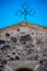Sardinia. Traditional architecture. Iron Cross on the facade of the medieval church of Santa Maria de Is Acquas, near Sardara