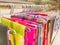 Sarees hanging on hangers in a textile showroom