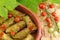 Sarma rolls in a traditional plate and cherry tomato