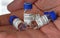 SARS-Cov-2 coronavirus clinical trial vaccines, four small bottles with blue caps in man hand, closeup detail own sticker design