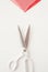 Sartorial scissors, pieces of colored fabric on a white background